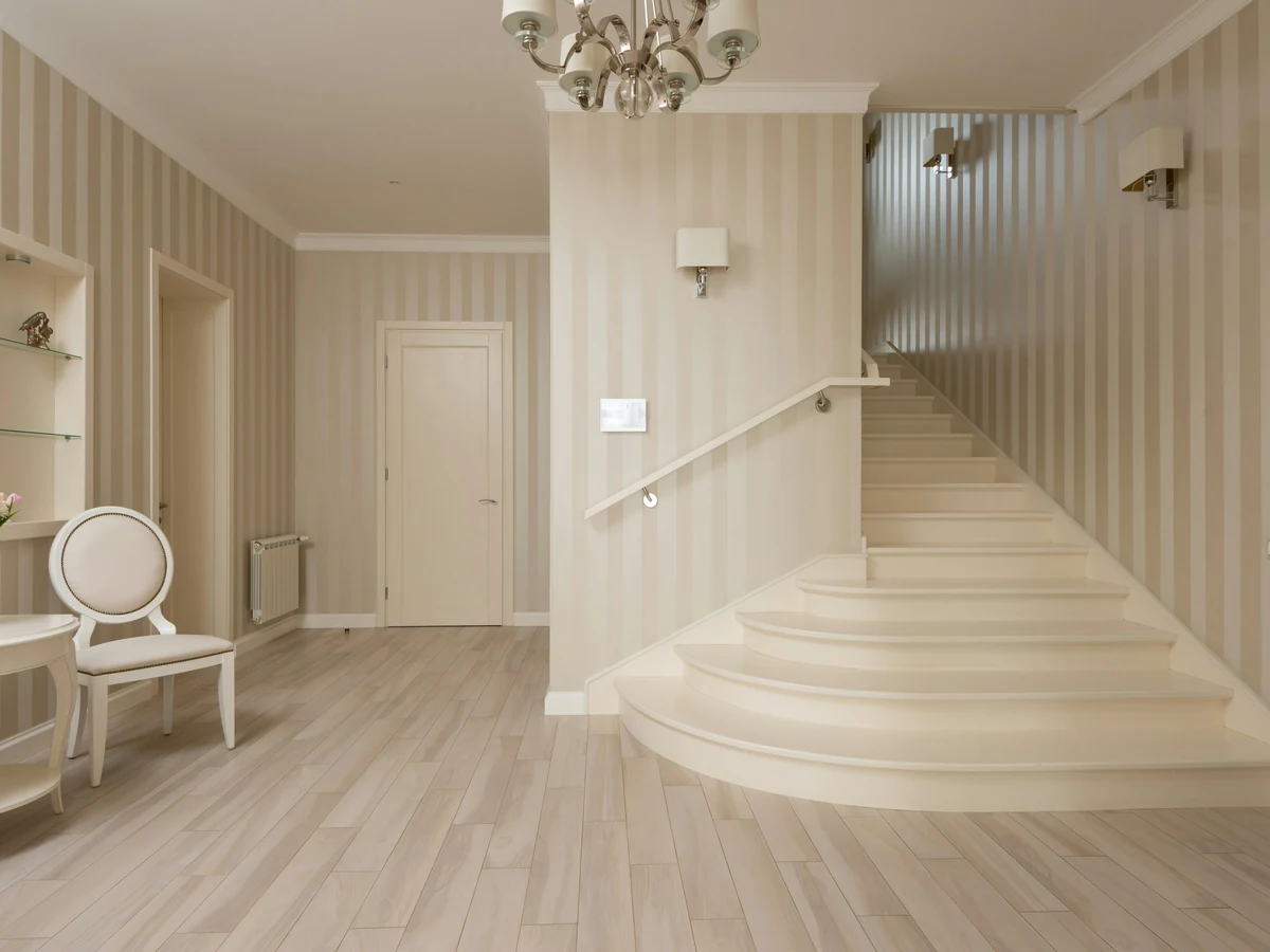 Bedroom painting with floral wallpaper in Cirencester by Cotswolds Decorators, bedroom painters