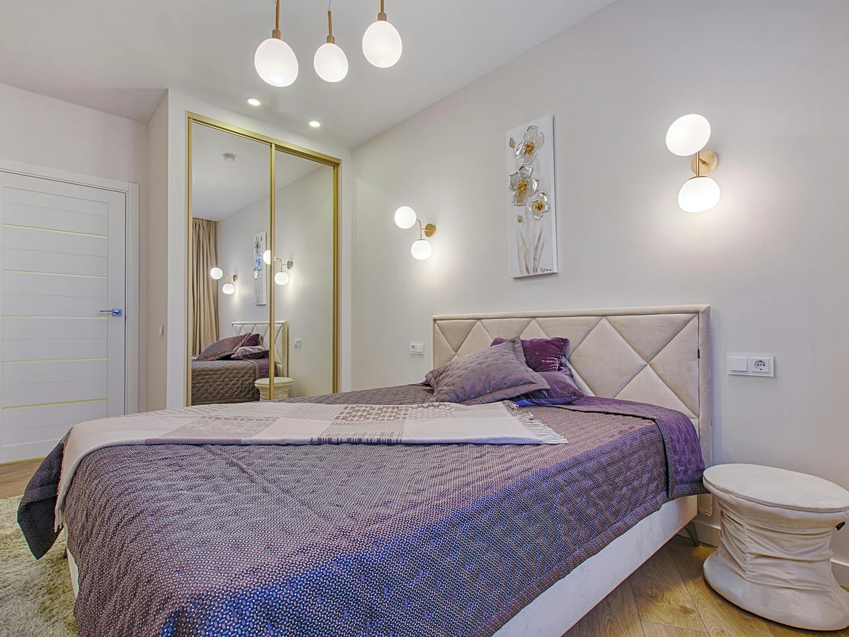 Bedroom painting with purple bedding in Cotswolds by Cotswolds Decorators