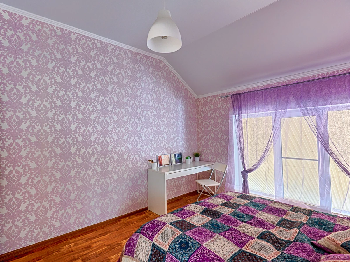 Bedroom with purple patterned walls painted by Cotswolds Decorators
