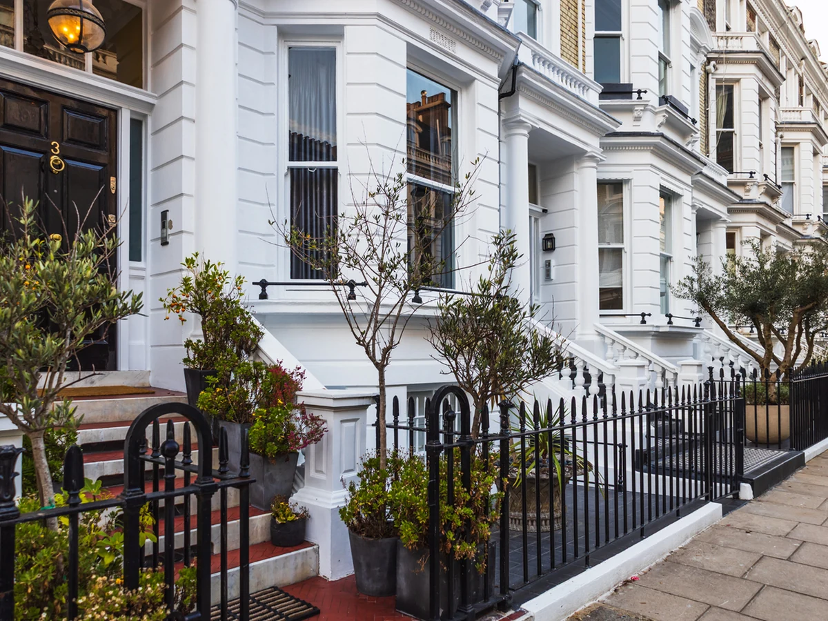 Exterior painting on white Victorian townhouses in Fairford by Cotswolds Decorators