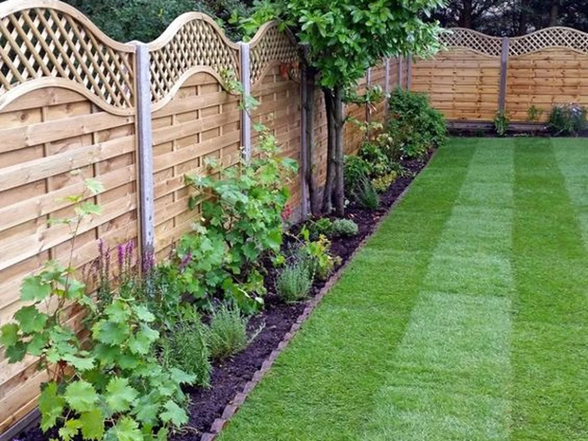 Decorative wooden garden fence painted by Cotswolds Decorators