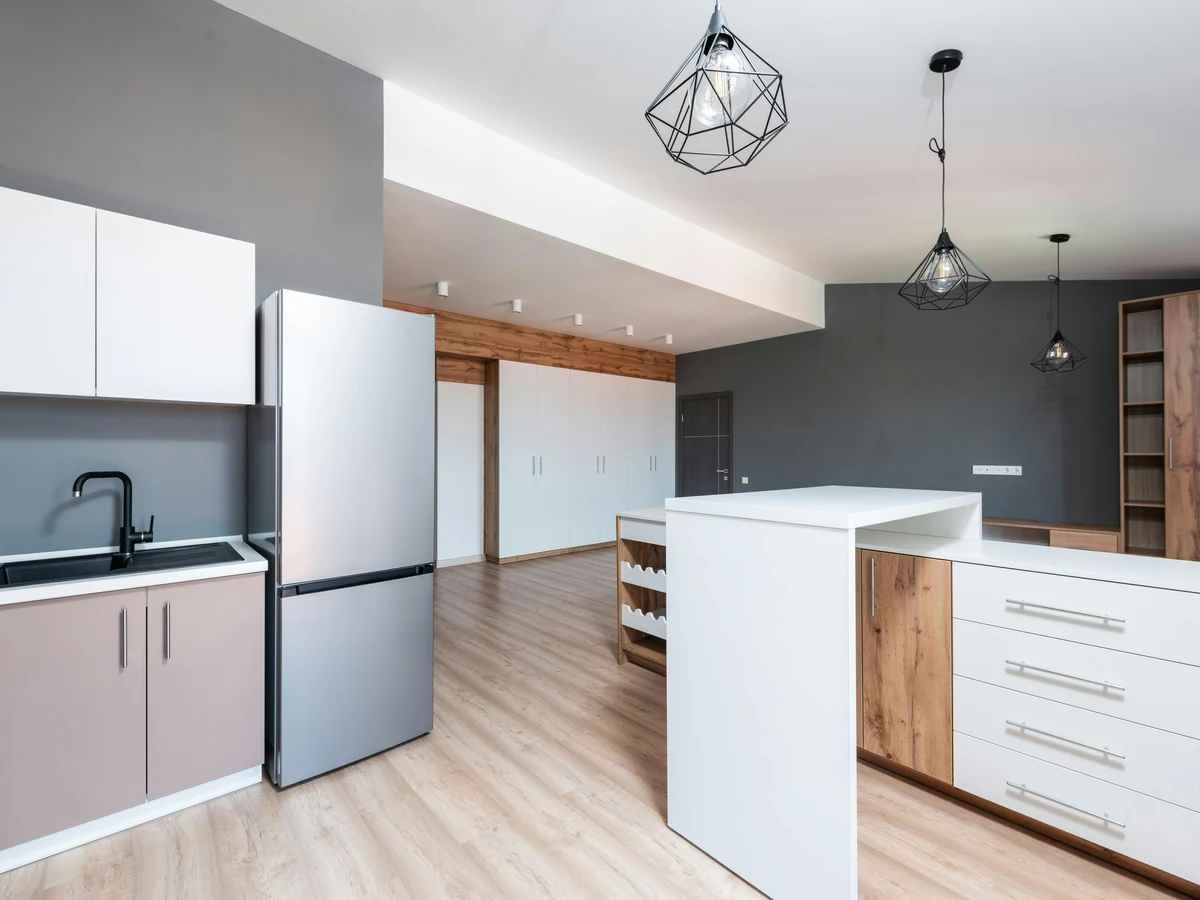 Open plan grey kitchen repainted by Cotswolds Decorators