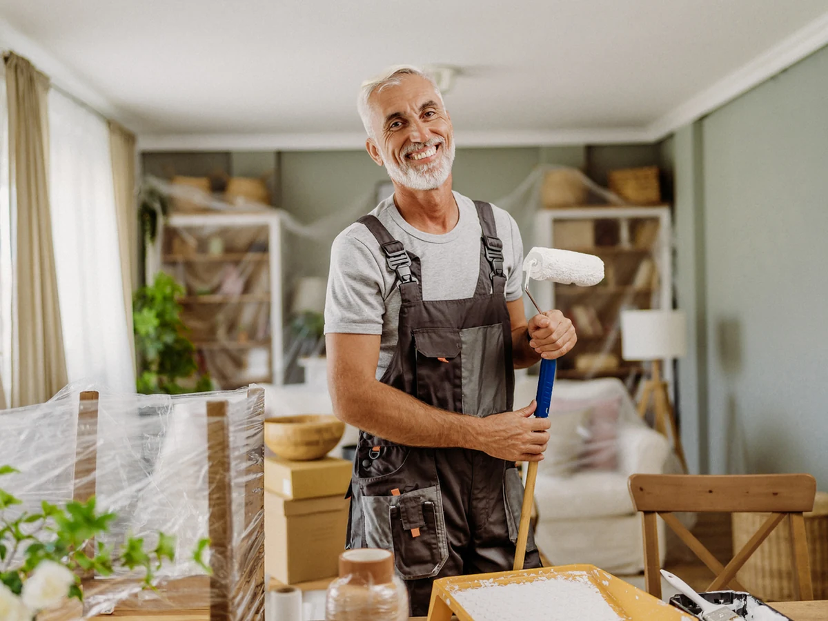 Painter holding decorating tools in Fairford property by Cotswolds Decorators